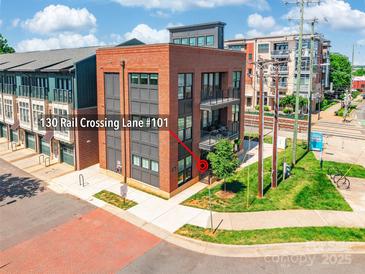 Brick condominium building with a modern design and balcony at 130 Rail Crossing Lane #101 at 130 Rail Crossing Ln # 101, Charlotte, NC 28209