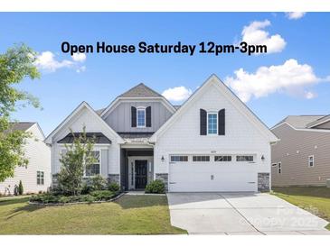 Charming two-story home featuring a manicured lawn, a two-car garage, and decorative shutters, ideal for Gathering living at 14210 Asbury Park Rd, Huntersville, NC 28078