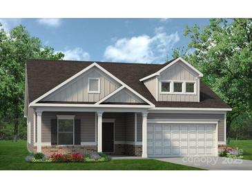 Charming home with a two-car garage, gray siding, and a well-manicured lawn at 1234 Arnold Way, Mount Pleasant, NC 28025