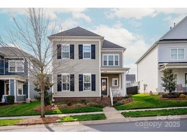 Charming two-story home features a well-maintained front yard and classic architectural details at 13818 Jacks Ln, Pineville, NC 28134