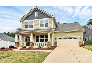 Charming two-story home with a welcoming front porch and well-maintained lawn at 16019 Kelby Cv, Charlotte, NC 28278
