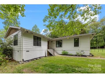 Charming single-story home with white siding, black-framed windows, and a well-maintained lawn at 17403 Green Hill Rd, Charlotte, NC 28278