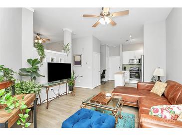Open living room with hardwood floors, high ceilings, modern furniture, and lots of natural light at 2125 Southend Dr # 339, Charlotte, NC 28203