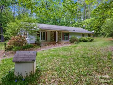 Charming ranch home featuring stone accents, red shutters and a inviting front porch at 231 Stockwood Dr, Stanley, NC 28164