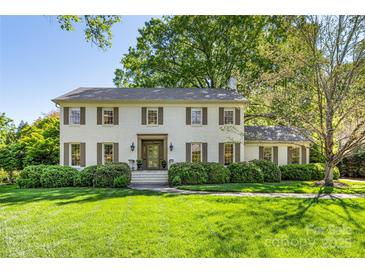 Charming two-story brick home with mature landscaping and a well-manicured lawn at 2501 Richardson Dr, Charlotte, NC 28211