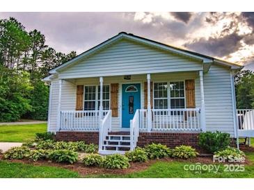 Charming one story home with a welcoming front porch and well-manicured landscaping at 2551 Glenwood St, Kannapolis, NC 28083