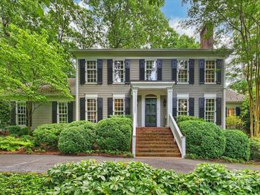 Charming two-story home with a brick stairway, complemented by lush landscaping and a welcoming facade at 3040 Valencia Ter, Charlotte, NC 28211