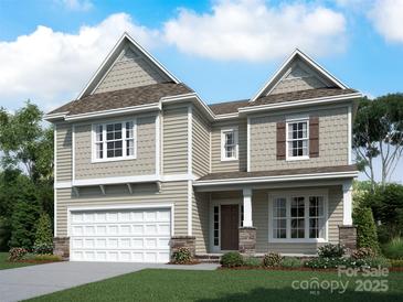 Charming two-story home with a two-car garage, manicured lawn, and welcoming front porch at 4019 Zinnia Dr # Cgw0125, Harrisburg, NC 28075