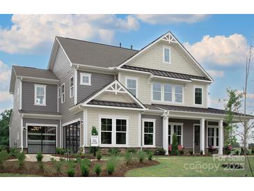 Beautiful two-story home showcasing a modern design and complemented by lush landscaping in a suburban neighborhood at 504 Meadow Ridge Dr, Belmont, NC 28012
