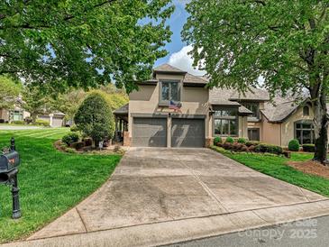 Charming two-story home with a large driveway and well-manicured landscaping at 5603 Ballinard Ln, Charlotte, NC 28277