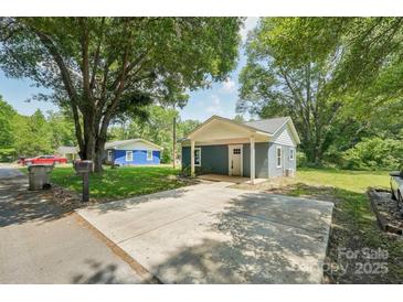 Charming blue home with a large driveway and a welcoming covered porch at 814 Marve St, Gastonia, NC 28052