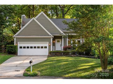 Charming home with a well-maintained lawn, two-car garage, and inviting front entrance at 9002 Maple Hill Ct, Huntersville, NC 28078