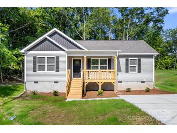 Charming one story home with a covered front porch, gray siding, black shutters, and green lawn at 951 Hardin Dr, Shelby, NC 28150