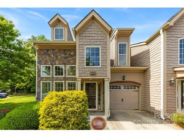 Charming townhome featuring stone accents, shingle siding, and an attached garage in a desirable neighborhood at 1161 Stuarts Landing Dr, Cramerton, NC 28032