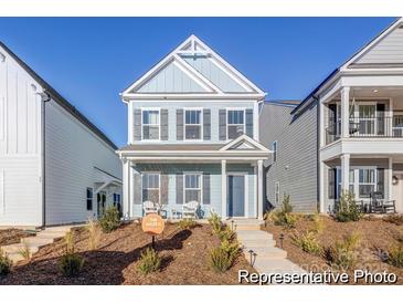Charming two-story home with blue siding, covered front porch, and well-maintained landscaping at 1359 Russell St, Rock Hill, SC 29730