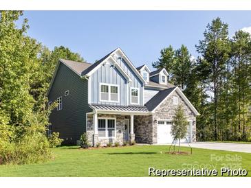 New construction home with stone accents, charming dormers, gray siding and covered porch at 1359 Russell St, Rock Hill, SC 29730