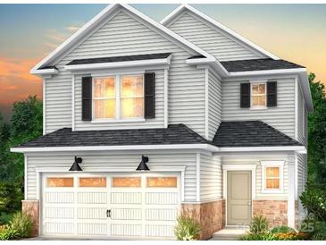 Charming two-story home with a two-car garage and professionally landscaped front yard at 14015 Penbury Ln # 373, Charlotte, NC 28278