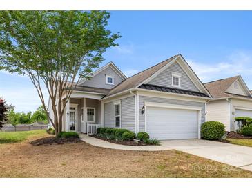 Charming gray home featuring a well-manicured front yard and attached two-car garage at 16291 Raven Crest Dr, Indian Land, SC 29707