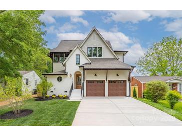 Beautiful two-story home boasting a manicured lawn, two-car garage, and charming architectural details at 1816 Parson St, Charlotte, NC 28205