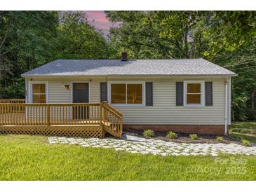 Charming home featuring a well-maintained yard, wooden deck, and stone pathway to the front door at 2603 Mary Ave, Gastonia, NC 28052