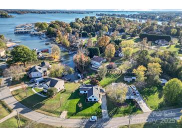 Gorgeous aerial view of the home nestled in a lush neighborhood with access to the lake and marina at 317 Commodore Loop, Mooresville, NC 28117