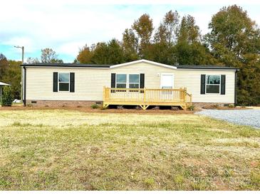 Charming single-story home with a welcoming wooden deck and manicured lawn at 445 Davis Rd, Shelby, NC 28152