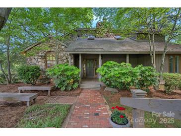 Charming stone facade home with a welcoming brick walkway and covered front entrance at 5915 Mammoth Rd, Charlotte, NC 28270