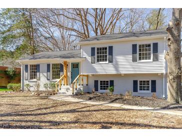 Charming two-story home with white siding, black shutters, and a light blue front door at 6706 Queensberry Dr, Charlotte, NC 28226
