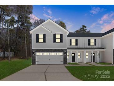 Two story home with a gray and white color scheme, black shutters, and a two car garage at 1604 Breezewood Dr, Charlotte, NC 28262