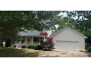 Charming home with a two-car garage and a cozy front porch nestled under mature trees at 165 Graceland Pl, Salisbury, NC 28146
