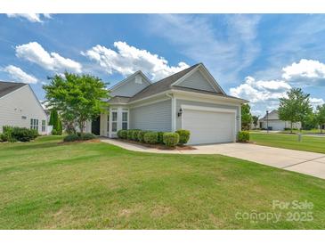 Charming single-story home with a well-manicured lawn, tidy landscaping, and a two-car garage at 23147 Whimbrel Cir, Fort Mill, SC 29707