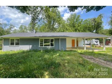 Charming single story home with a brick exterior, large covered parking area and a large front yard at 2322 Hedgewood Cir, Gastonia, NC 28052