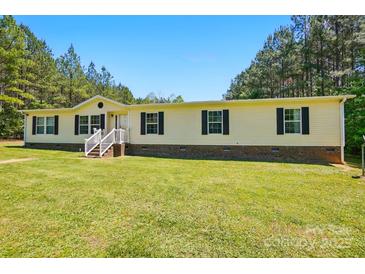 Single level home with yellow siding and black shutters in a green lawn setting at 2784 Leadoff Rd, Lancaster, SC 29720