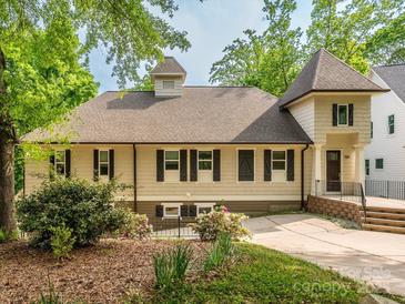 Charming home featuring light siding, dark shutters, and mature landscaping in a tranquil setting at 7324 Leharne Dr, Charlotte, NC 28270