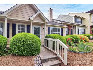 Charming home featuring manicured landscaping, a quaint walkway, and a welcoming entrance at 9232 Four Mile Creek Rd, Charlotte, NC 28277