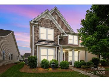 Charming two-story home featuring stone accents, covered front porch, and manicured landscaping at 1004 Craven St, Indian Trail, NC 28079