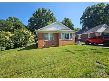 Charming single-story brick home with a well-maintained lawn, mature trees, and sunny blue skies at 124 10Th Sw St, Conover, NC 28613