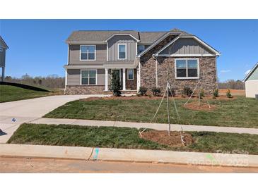 Beautiful two-story home featuring a stone and gray siding exterior and a well-manicured lawn at 2075 Fordhill St, Rock Hill, SC 29732