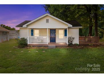 Charming single-story home featuring a welcoming front porch, lush lawn, and well-maintained landscaping at 2729 S Ridge Ave, Concord, NC 28025