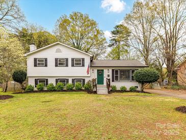Charming two-story home featuring a freshly manicured lawn and beautiful landscaping at 2816 Eastport Rd, Charlotte, NC 28205