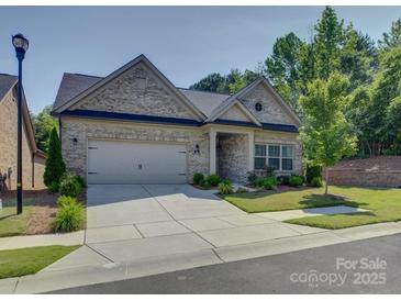 Charming single-Gathering home with a well-manicured front yard and a two-car garage at 3002 Portico Pl, Tega Cay, SC 29708