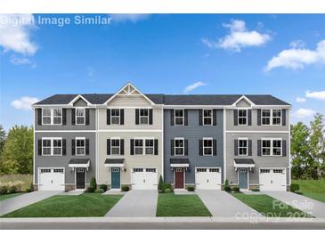 Beautiful new construction townhomes with manicured lawns and individual garages offer a modern design and curb appeal at 5782 Knox Ln, Kannapolis, NC 28081