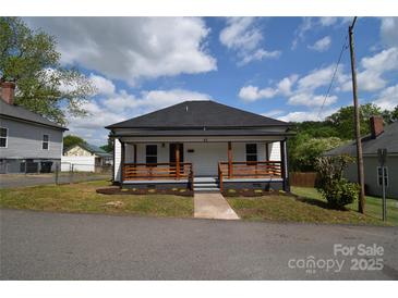 Charming home with a inviting front porch with a black roof, and landscaped front yard at 62 Fourth St, Cramerton, NC 28032