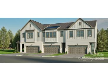 Newly constructed townhomes with modern farmhouse design, featuring attached garages and a well maintained lawn at 808 Garringer Pl, Charlotte, NC 28208