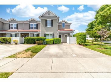 Charming two-story townhome with well-maintained landscaping, front yard and private parking at 1006 Phil Oneil Dr, Charlotte, NC 28215
