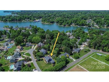Expansive waterfront home with mature trees and lush landscaping along the shores of Lake Norman at 106 Chatworth Ln, Mooresville, NC 28117