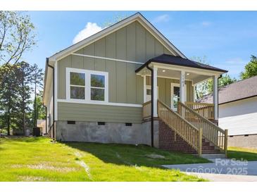 Charming home with a cozy front porch and light green siding at 1103 Kenly St, Salisbury, NC 28144