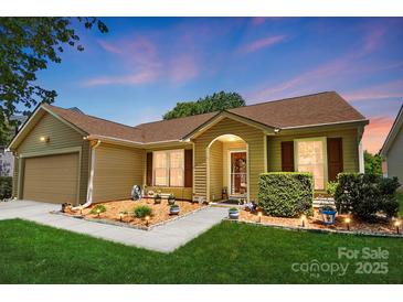 Charming single-story home with manicured lawn, sidewalk lighting, and inviting entrance at 118 Winborne Dr, Mooresville, NC 28115