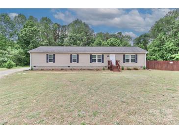Charming single-story home with a well-maintained lawn, complemented by a backdrop of lush greenery at 119 Marietta Rd, Mooresville, NC 28117