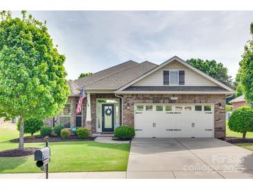 Charming brick home featuring an attached two-car garage, manicured lawn, and an inviting front entrance at 14113 Highland Meadow Rd, Charlotte, NC 28273